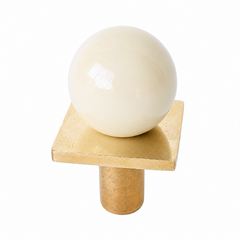 colorful and structural drawer pull features a powdercoated cream colored ball on a brass square with a small foot, making it easy to grab as well as gorgeous. Made with real brass, this knob will patina with time if you want it to. 