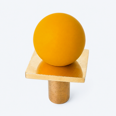 colorful and structural drawer pull features a powdercoated matte mustard colored ball on a brass square with a small foot, making it easy to grab as well as gorgeous. Made with real brass, this knob will patina with time if you want it to. 