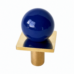 colorful and structural drawer pull features a powdercoated navy blue colored ball on a brass square with a small foot, making it easy to grab as well as gorgeous. Made with real brass, this knob will patina with time if you want it to. 
