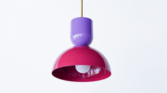 Jewel tones love company, and this two-tone Taeuber pendant pairs a glossy orchid purple cup top with a deep black cherry dome for a rich, saturated combination. Joined by a warm brass stem, it reads bold, a little sultry, and very custom, the kind of statement lighting that turns a kitchen island, breakfast nook, or bar into a real focal point. Hang one for a hit of unexpected color or a row for drama. A great choice for a maximalist, collected home that loves a moody, grown-up palette and a clever color-b