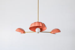 Peach and brass coastal instpired shell chandelier has a playful art deco vibe with its brass accents