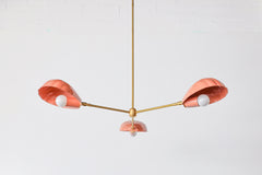 Peach and brass coastal instpired shell chandelier has a playful art deco vibe with its brass accents