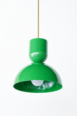 True grass green is the color that makes a kitchen feel happy and alive, and this Taeuber pendant leans right into it. The two-part silhouette stacks a rounded cup over a wide domed bell, all finished in a glossy spring green with a warm brass stem, shown here lit and glowing. It reads bold, cheerful, and very design-forward, the kind of statement lighting that turns an island, breakfast nook, or sink into a real focal point. Hang one as a jolt of color or a row for maximum impact. A great choice for a maxi