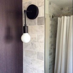 marble tile bathroom remodel black light fixture black sconce laurel sazerac stitches home renovation