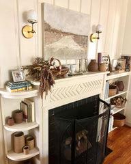 neutral living room fireplace mantle with adjustable west end sconces