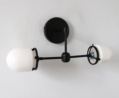 matte black modern two light wall sconce with white glass shades