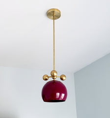 maroon black cherry and brass modern globe pendant chandelier with brass orb ball details midcentury inspired