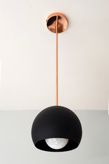 polished copper and matte black modern globe pendant