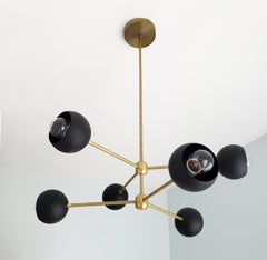 Black and brass mid-century modern inspired chandelier with orbs