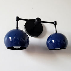 mid century modern inspired two light wall light with globe shades in navy and matte black.  Great for modern bathroom renovations, kids bathrooms, etc.
