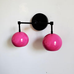 pink and black midcentury modern two light wall sconce in bright fun colors