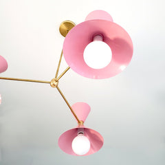 Pink and brass mid century modern three light chandelier for commercial spaces, dining rooms, colorful decor