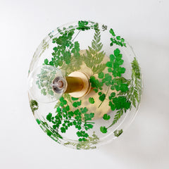 handmade flora wall sconce or flush mount ceiling light with shades of green, brass, and clear resin. side view