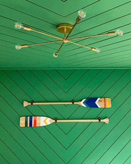 brass ceiling light on a green ceiling and walls