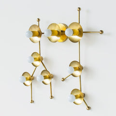 Brass sconce or flush mount ceiling light in the shape of  the Gemini constellation.  Astrology inspired light fixture - side view