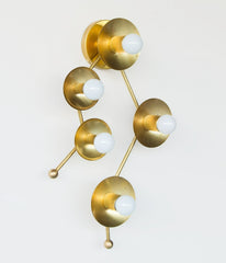 Brass sconce or flush mount ceiling light in the shape of  the Gemini constellation.  Astrology inspired light fixture - gemini constellation from the side