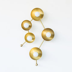 Brass sconce or flush mount ceiling light in the shape of  the Gemini constellation.  Astrology inspired light fixture front view