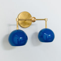 blue and brass mid century modern style wall sconce with two sockets
