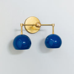 mid century modern style blue and brass two light bathroom wall sconce