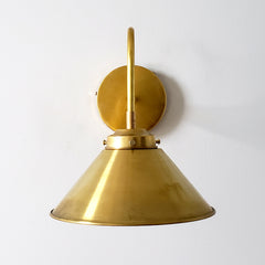all brass wall sconce with a cone shade.  Great for modern farmhouse kitchens and open shelving