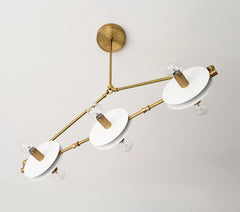 White and Brass Valerie chandelier by Sazerac Stitches - inspired by midcentury modern Italian design. features crisp brass and white finishes in a linear shape