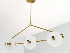 White and Brass Valerie chandelier by Sazerac Stitches - inspired by midcentury modern Italian design. features crisp brass and white finishes in a linear shape