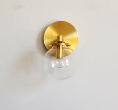 modern brass wall sconce with clear shade bathroom lighting globe