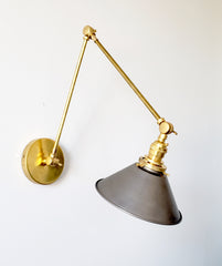 steel and brass industrial style adjustable sconce with cone shade