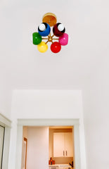 White Bedroom with brass rainbow short chandelier