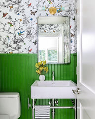 Green bathroom with butterfly and flower wallpaper, chrome hardware, and traditional design