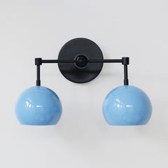 Pastel blue and black two light wall sconce front view