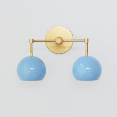Brass and pastel blue two light mid century modern wall sconce for bathroom renovations