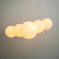 Lit up art deco inspired chandelier with large white globes
