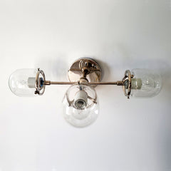 chrome and clear glass three light wall sconce for modern bathroom renovations