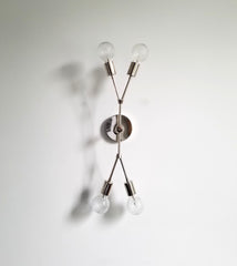 vertical four light wall sconce in chrome with crystal bulbs