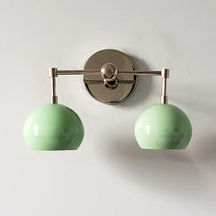 Mint and chrome two light wall sconce that is midcentury modern inspired