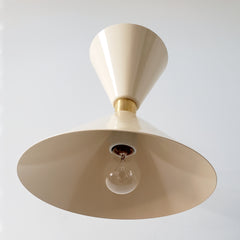 Cream and brass midcentury modern inspired cone wall sconce