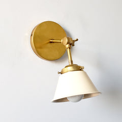 Cream and brass small adjustable wall sconce perfect for bedrooms, living rooms, dining rooms, and bedside lighting