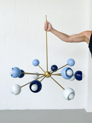 Pastel blue, Navy, and white sputnik chandelier with brass accents and hardware.  Bold sputnik style chandelier