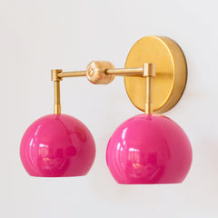 Bright Pink and brass two light mid century modern wall sconce  - side view