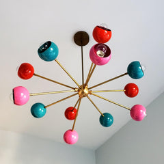 multicolored mid century modern sputnik style chandelier with pink orange and teal