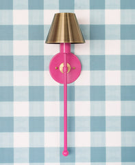 hot pink and brass wall sconce on gingham paper