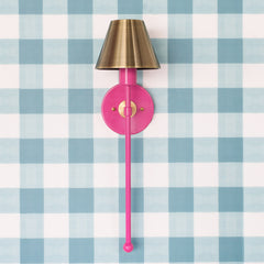 hot pink and brass modern wall sconce on blue gingham wallpaper