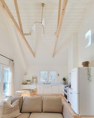 scandinavian style white and wood kitchen and open living space or cabin