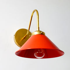 Poppy red or flame orange wall sconce with brass hardware.  This colorful mid century modern style wall sconce is great for kitchens, bathrooms, bedrooms, etc.  Also fun for kids rooms.