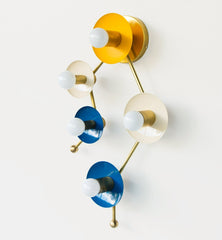Astrology inspired sconce in mustard, cream, and blue.  Shaped like part of the Gemini star constellation