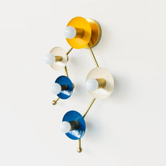 Astrology inspired sconce in mustard, cream, and blue.  Shaped like part of the Gemini star constellation