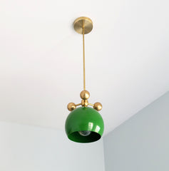 bright grass green and brass modern globe pendant chandelier with brass orb ball details midcentury inspired