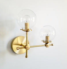 brass and clear glass globe L shaped wall sconce modernist midcentury modern contemporary wall lighting