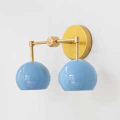 Pastel blue and brass mid century modern two light bathroom sconce side view